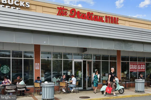 a view of a building with seating space and large windows