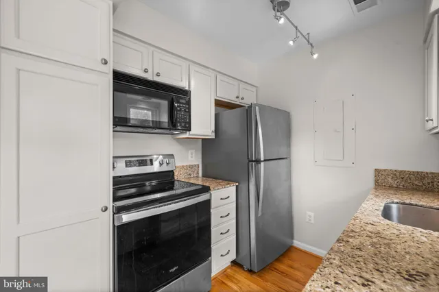 a kitchen with a refrigerator stove and microwave