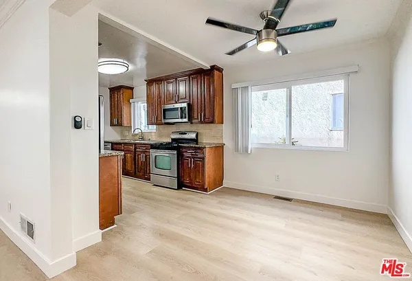 a kitchen with stainless steel appliances granite countertop a stove and a refrigerator