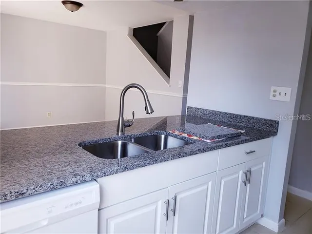 a kitchen with granite countertop a sink and a granite counter top
