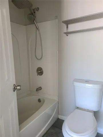 a bathroom with a toilet and a shower
