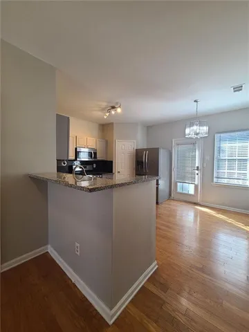 a view of kitchen with cabinets and wooden floor