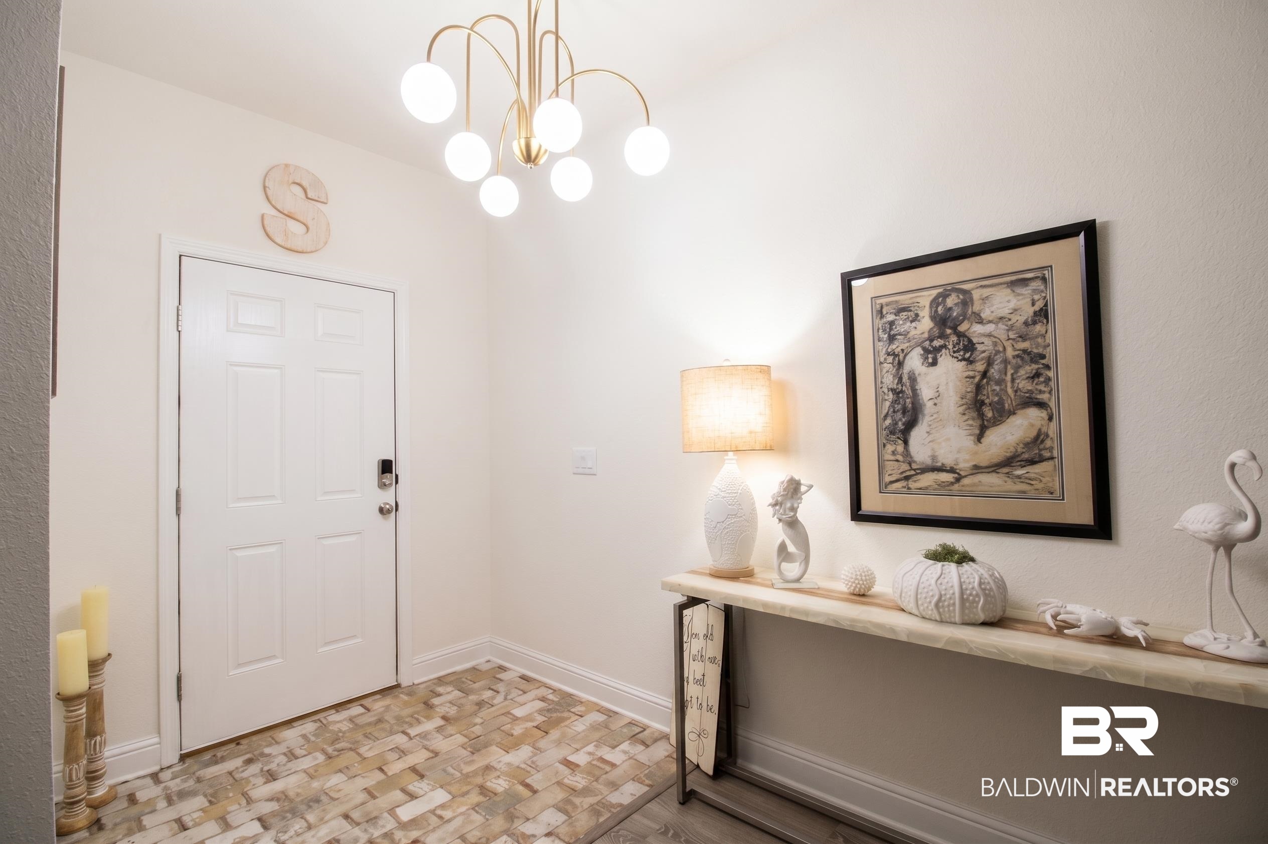 1885 Carly Street Foley, AL 36535 - Photo 9 of 40 Entryway featuring a four-panel entry door with smart lock, an overhead chandelier with globe lights, and brick-patterned tile flooring