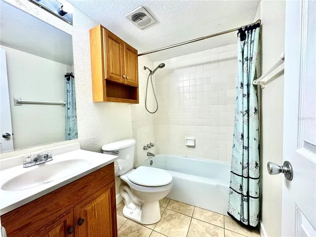 a kitchen with a stove sink and cabinets