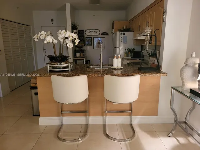a dining room with furniture and chandelier