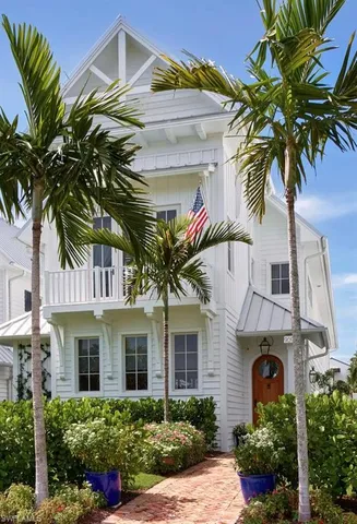 a front view of a house with a tree