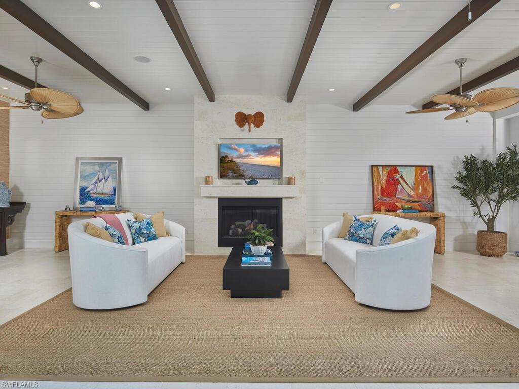 909 10th Avenue South Naples, FL 34102 - Photo 11 of 34 a living room with furniture and a fireplace