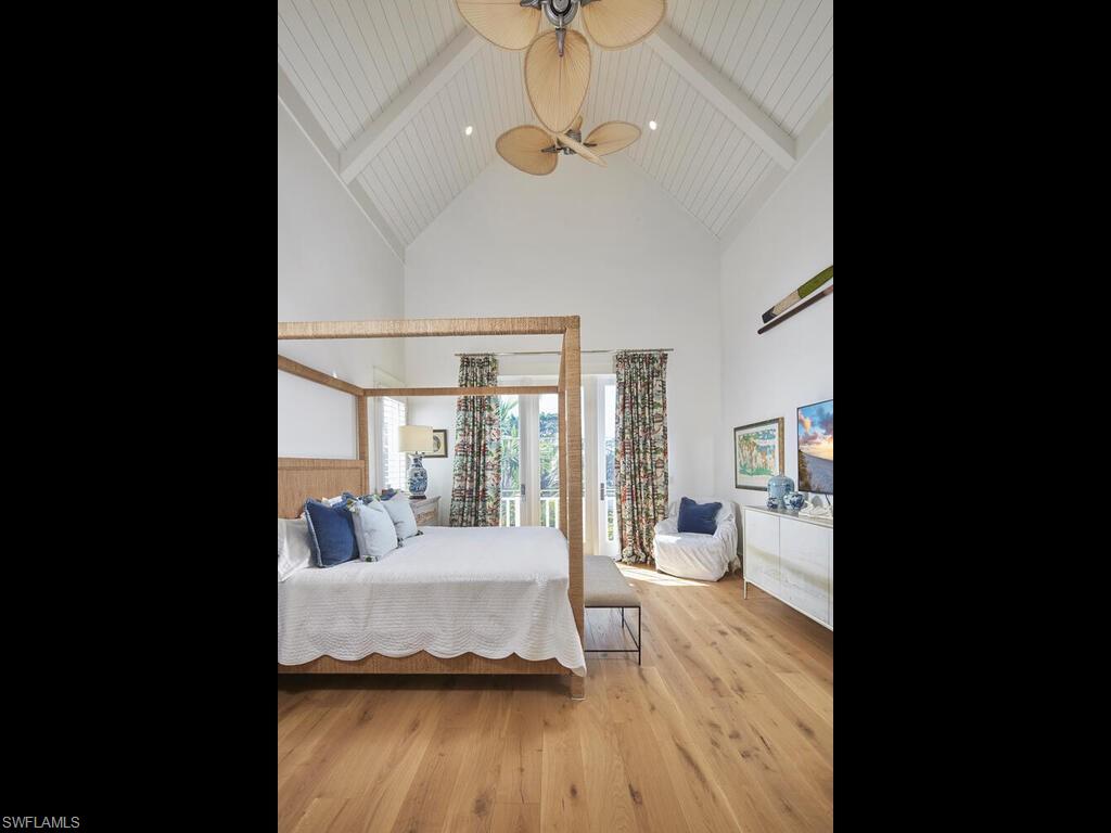 909 10th Avenue South Naples, FL 34102 - Photo 16 of 34 a living room with a bed and ceiling fan