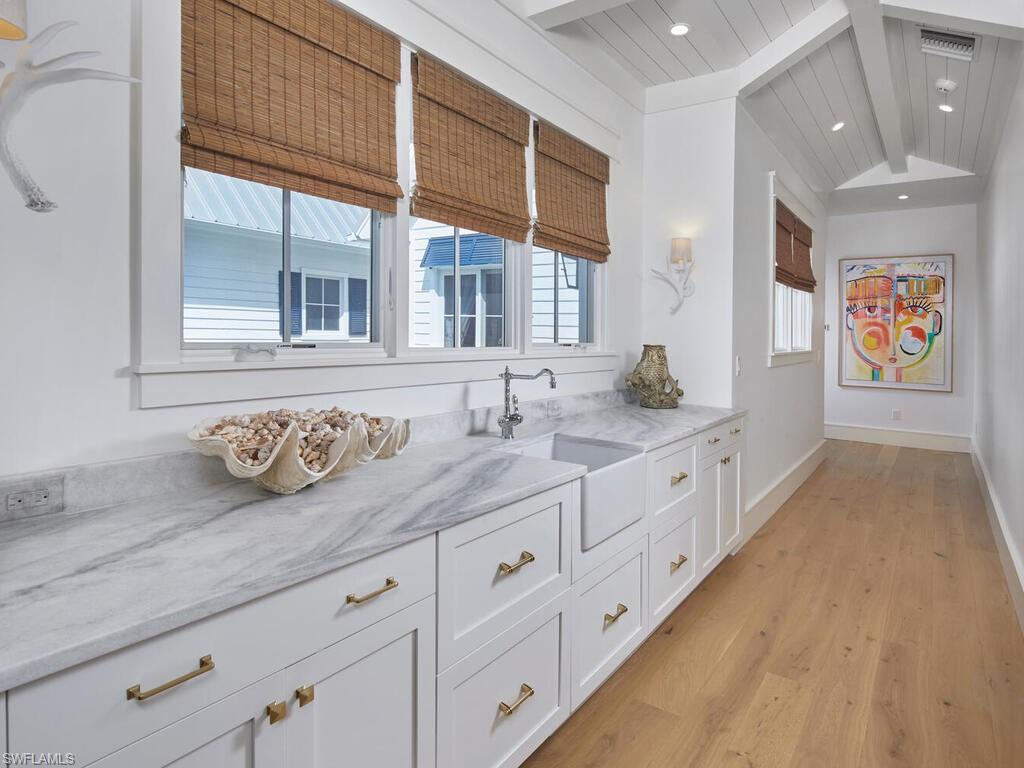 909 10th Avenue South Naples, FL 34102 - Photo 21 of 34 a spacious en suite bathroom with granite countertop double vanity