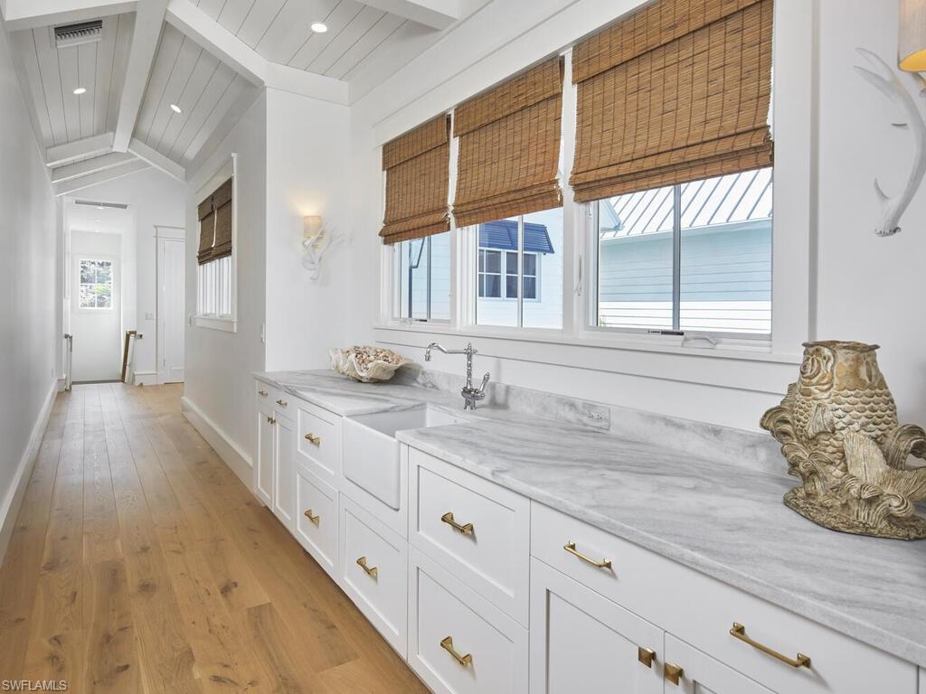 909 10th Avenue South Naples, FL 34102 - Photo 22 of 34 a bathroom with a granite countertop sink and a large mirror