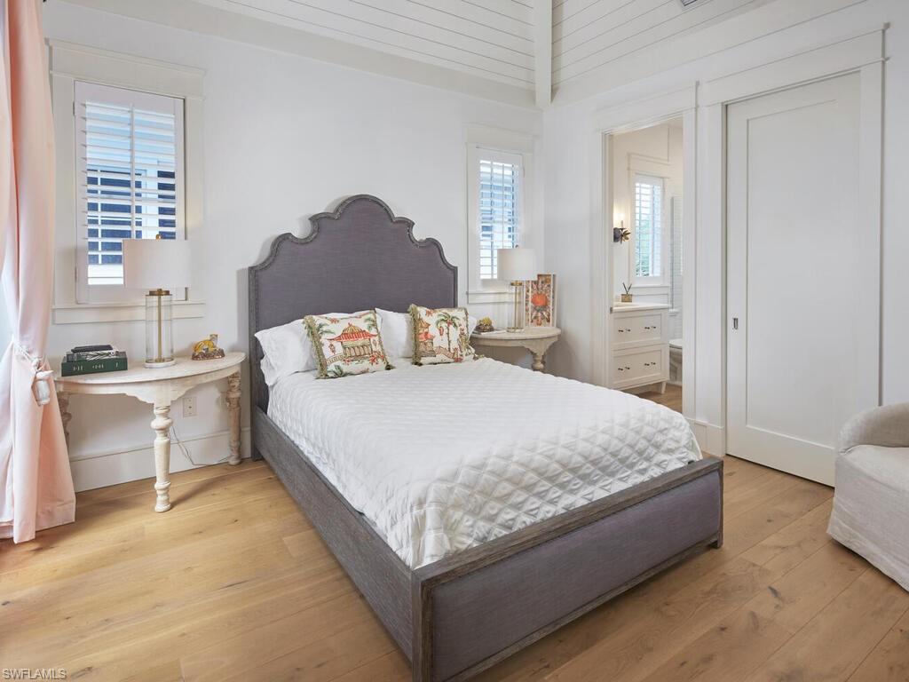 909 10th Avenue South Naples, FL 34102 - Photo 23 of 34 a bedroom with a bed and a couch