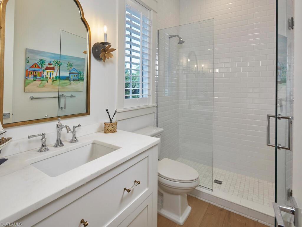 909 10th Avenue South Naples, FL 34102 - Photo 24 of 34 a bathroom with a sink a toilet and shower