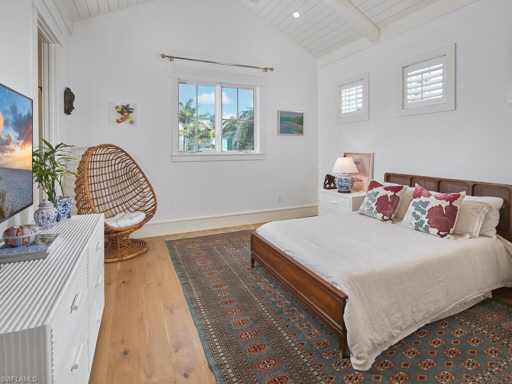 909 10th Avenue South Naples, FL 34102 - Photo 25 of 34 a bedroom with a bed and a couch