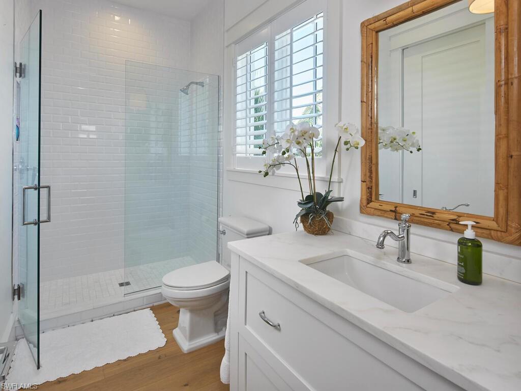 909 10th Avenue South Naples, FL 34102 - Photo 26 of 34 a bathroom with a sink a toilet and shower