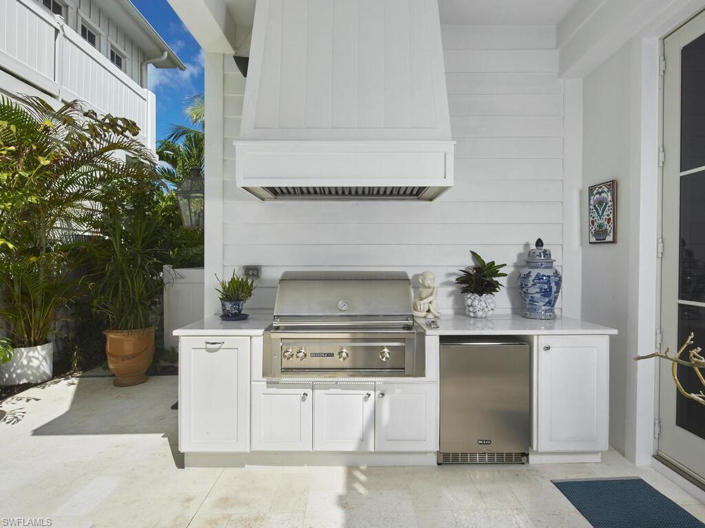 909 10th Avenue South Naples, FL 34102 - Photo 30 of 34 a stove top oven sitting inside of a kitchen