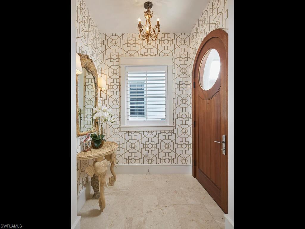 909 10th Avenue South Naples, FL 34102 - Photo 3 of 34 a view of a livingroom with wooden floor and a window