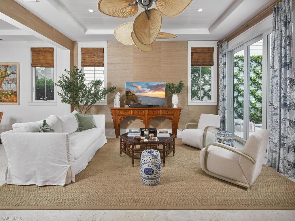 909 10th Avenue South Naples, FL 34102 - Photo 4 of 34 a living room with furniture fireplace and large windows