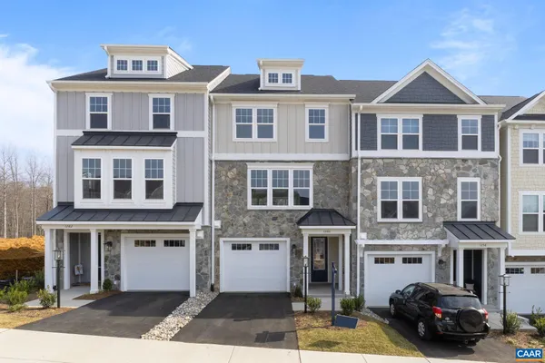 a front view of a residential apartment building with a yard