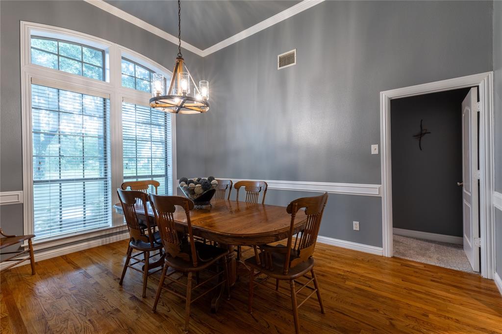 320 Rustic Oaks Road Combine, TX 75159 - Photo 16 of 40 Dining room with a chandelier, crown molding, and wood finished floors