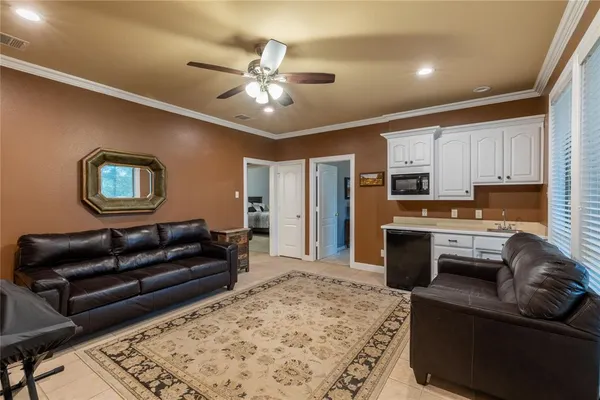 a living room with furniture and kitchen view
