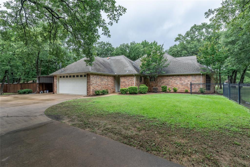 320 Rustic Oaks Road Combine, TX 75159 - Photo 3 of 40 Ranch-style house featuring driveway, an attached garage, brick siding, and a shingled roof