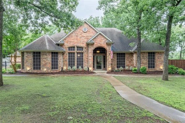 a front view of a house with yard patio and green space