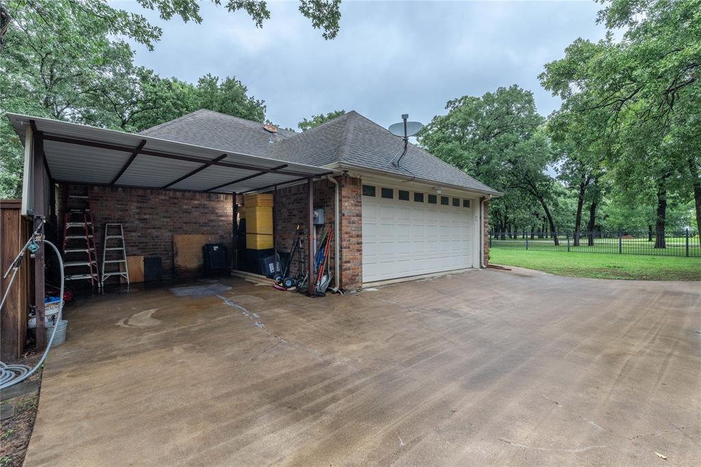320 Rustic Oaks Road Combine, TX 75159 - Photo 8 of 40 View of property exterior with concrete driveway, an attached garage, brick siding, and a shingled roof
