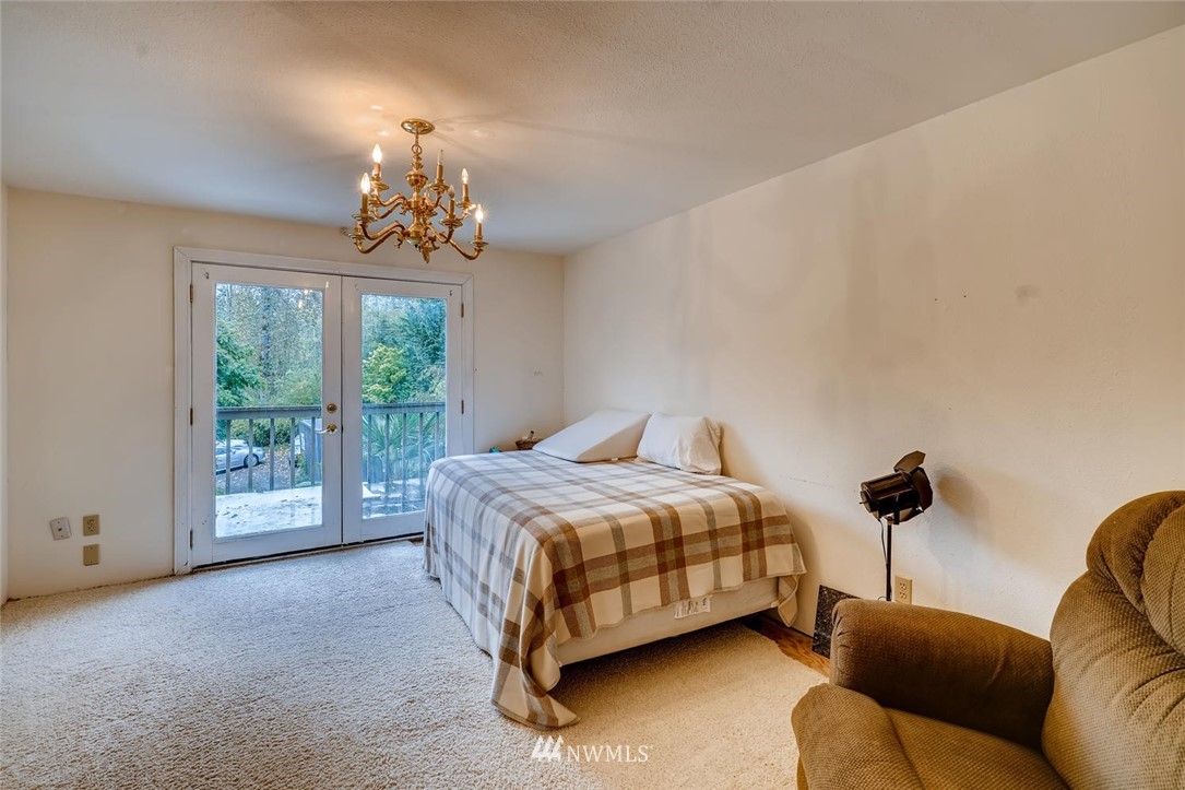 21612 High Bridge Road Monroe, WA 98272 - Photo 18 of 22 a bedroom with a bed couch chandelier and window