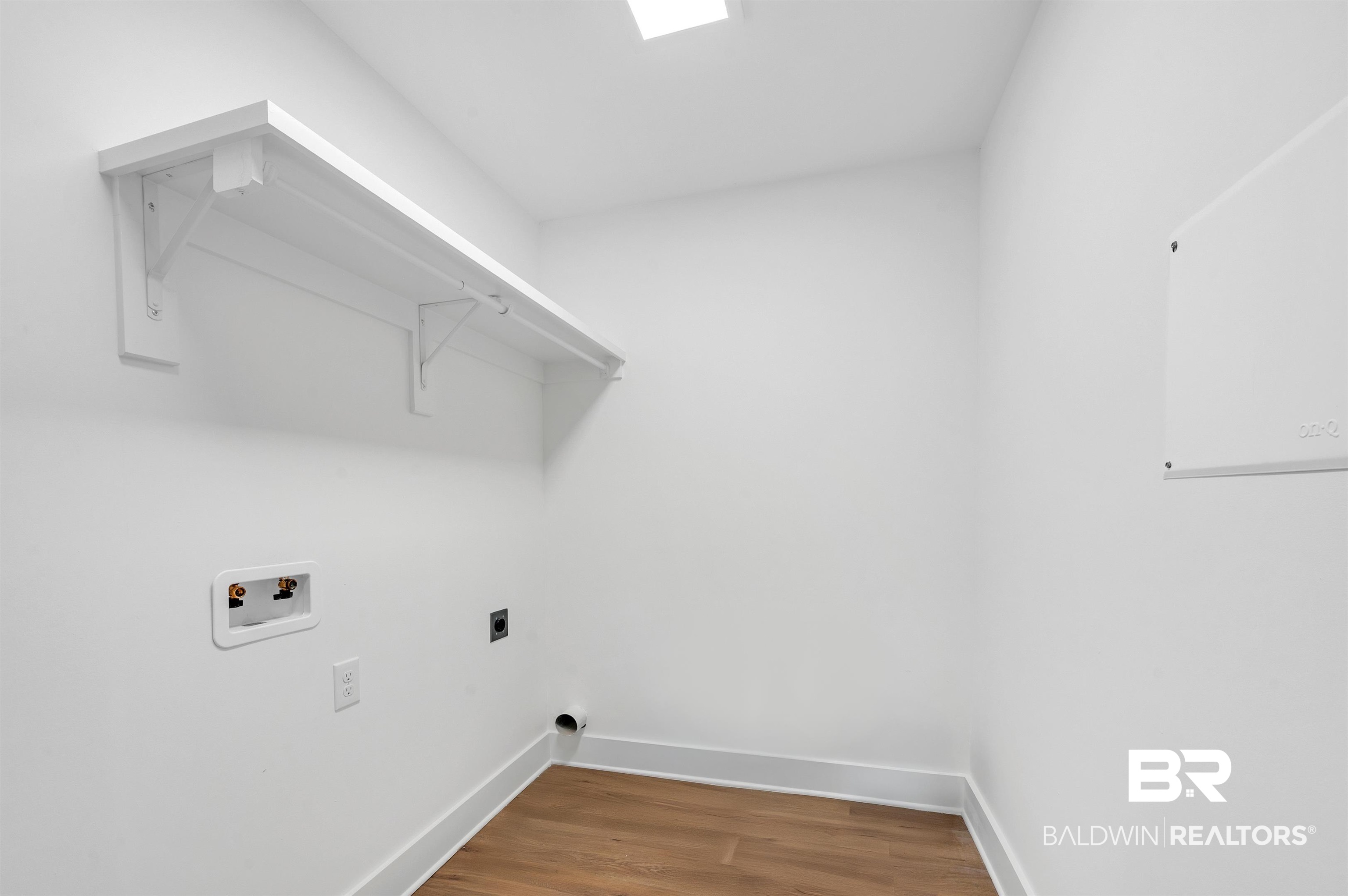22045 8th Street Silverhill, AL 36576 - Photo 21 of 39 Washroom with washer hookup, baseboards, wood finished floors, and hookup for an electric dryer