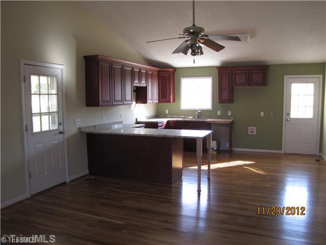 480 Helmstetler Road Lexington, NC 27295 - Photo 2 of 11 Kitchen. Large Kitchen w/custom cabinets, granite counters and SS microwave and dishwasher.