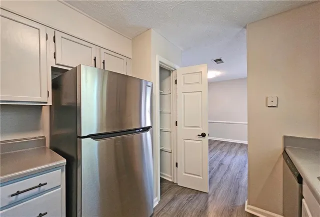 a view of kitchen with wooden floor and electronic appliances