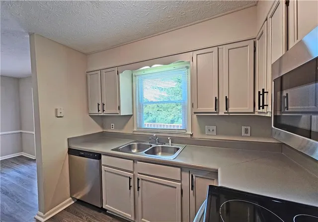 a view with a sink and a microwave