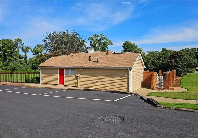 a backyard of a house with table and chairs