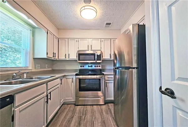 a kitchen with a refrigerator sink and microwave