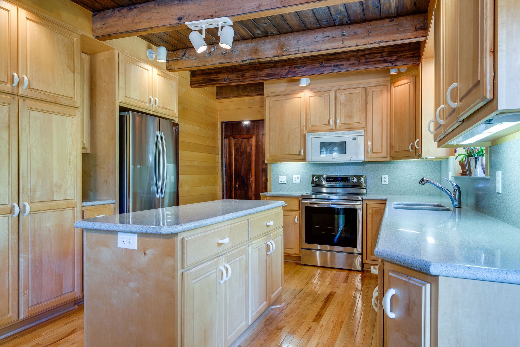 3093 Ivey Point Road Goodlettsville, TN 37072 - Photo 14 of 40 a kitchen with stainless steel appliances granite countertop a refrigerator a oven and white cabinets with wooden floors