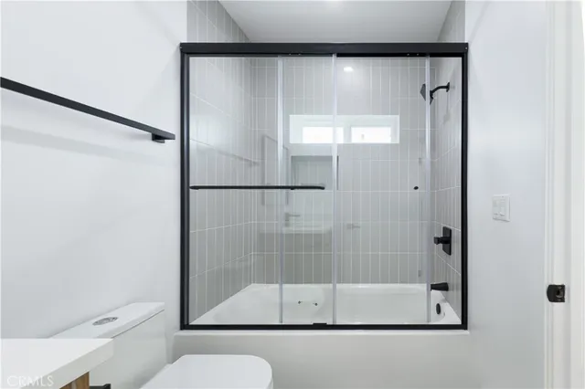 a bathroom with a glass shower door