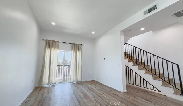 a view of hallway with wooden floor