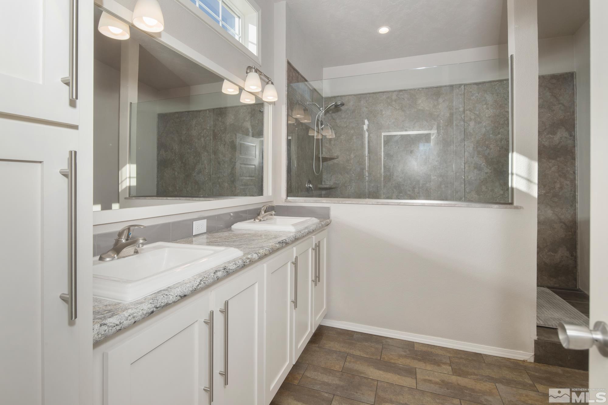 900 Ironwood Road Reno, NV 89510 - Photo 12 of 40 a bathroom with a granite countertop sink and a mirror