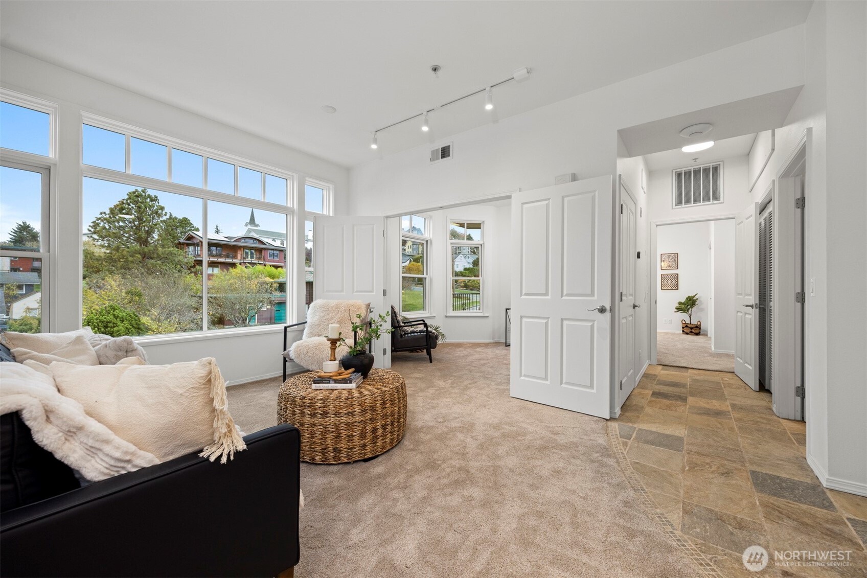 a living room with furniture and large windows