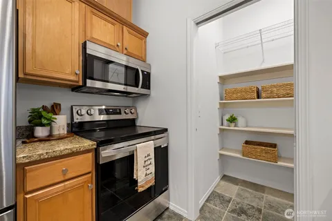 a view of a dining room with furniture and a potted plant