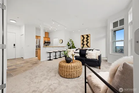 a view of living room with furniture and large window