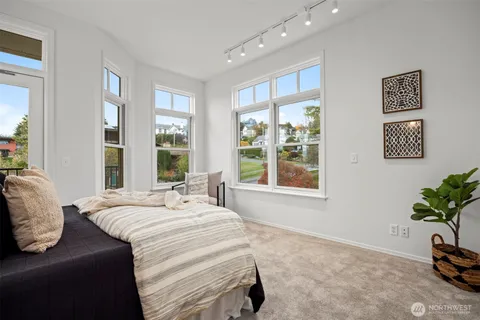 a spacious bedroom with a bed and a large window