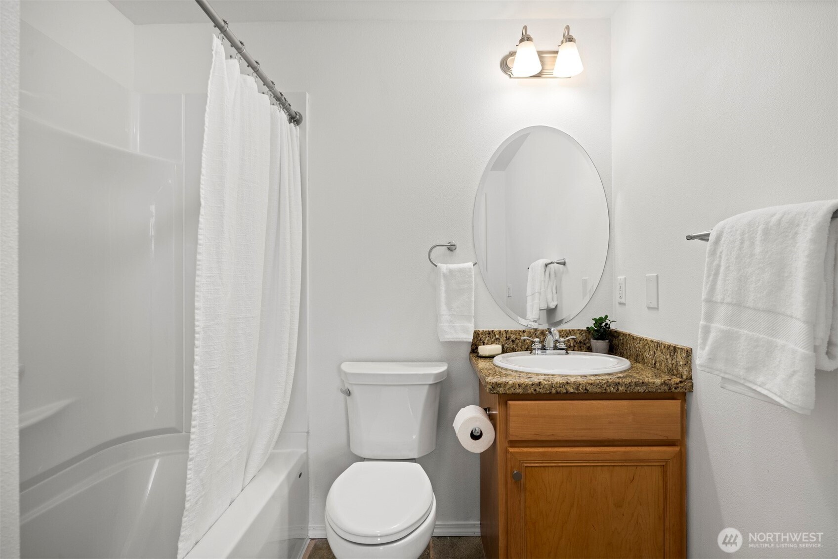 1201 13th Street, Unit 301 Bellingham, WA 98225 - Photo 27 of 38 a bathroom with a granite countertop toilet sink and mirror