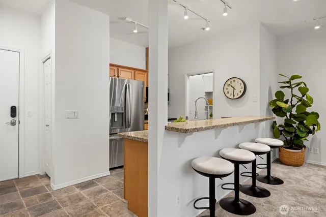 a view of entryway with furniture and wooden floor