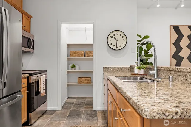 a kitchen with stainless steel appliances granite countertop a stove and a refrigerator