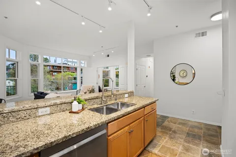 a kitchen with stainless steel appliances granite countertop a stove a microwave and cabinets