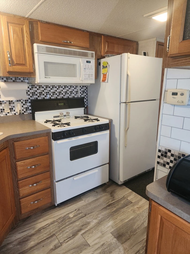 24-65 Woodhaven Lakes Sublette, IL 61367 - Photo 18 of 32 a kitchen with a stove and a refrigerator