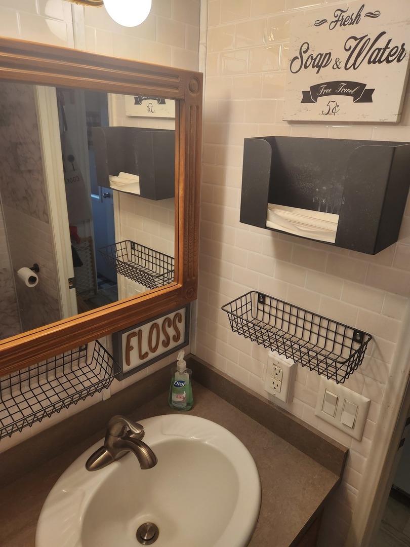 24-65 Woodhaven Lakes Sublette, IL 61367 - Photo 21 of 32 a bathroom with a sink and a mirror