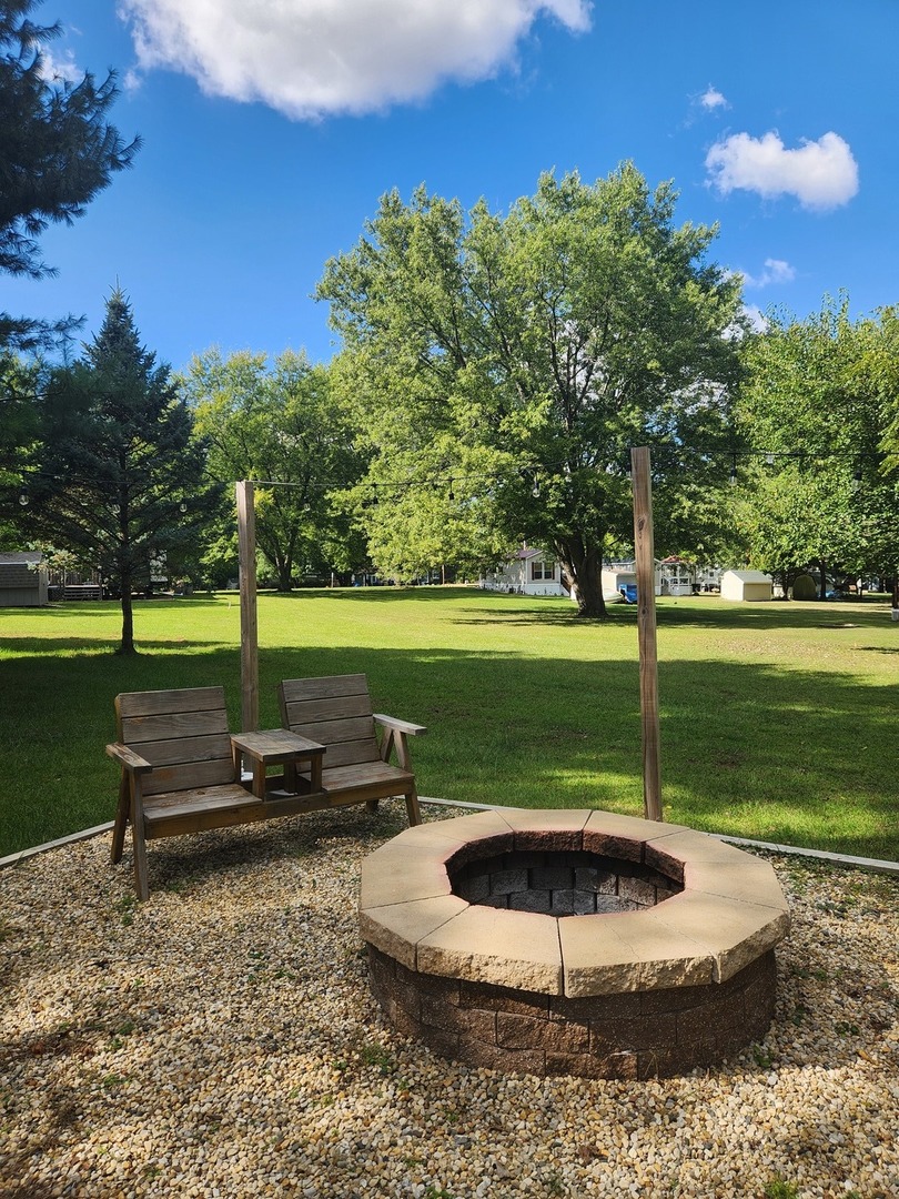 24-65 Woodhaven Lakes Sublette, IL 61367 - Photo 4 of 32 a view of a swimming pool and a yard