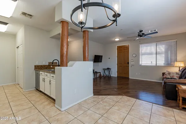 a kitchen with cabinets and wooden floor